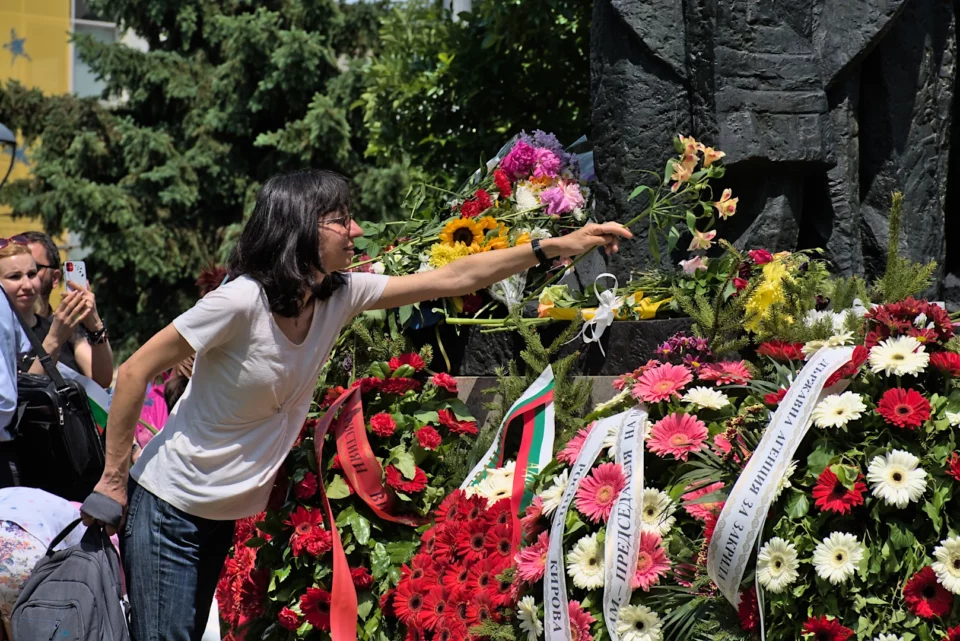 A woman puts flowers on the st. Cyril and Methodius monument